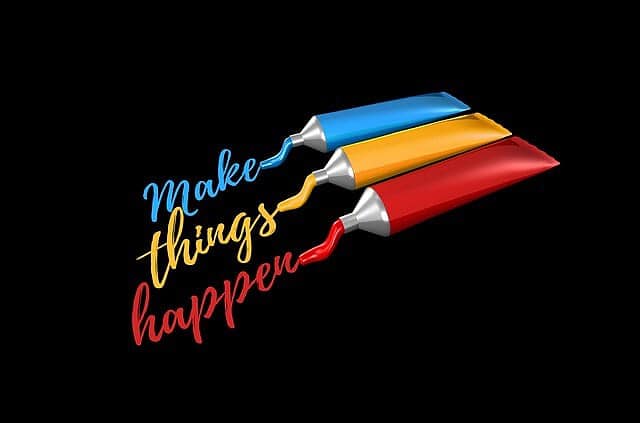Bright paint tubes with colorful text "Make things happen" against black background, inspiring creativity and motivation.